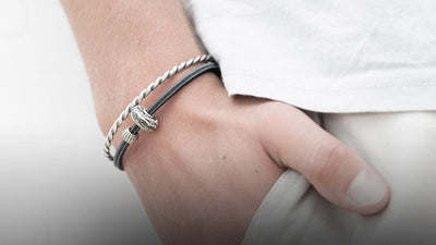 Twisted silver bangles and a leather bracelet with beads on model