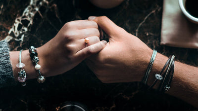 Couple holding hands wearing Trollbeads jewelry