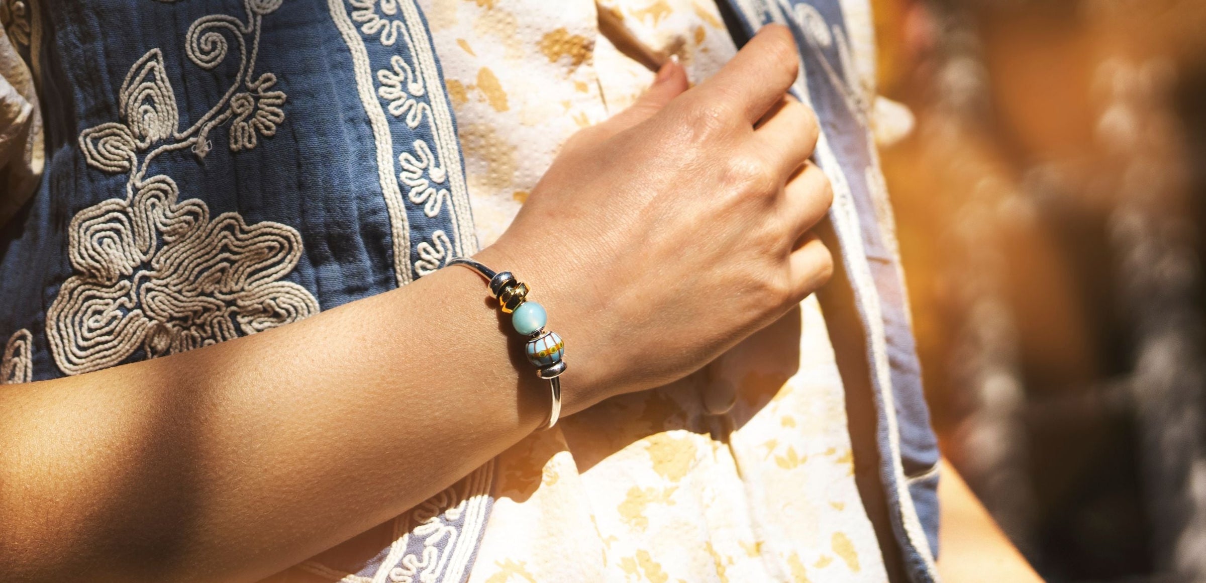 Woman wearing a silver plated bangle with beads